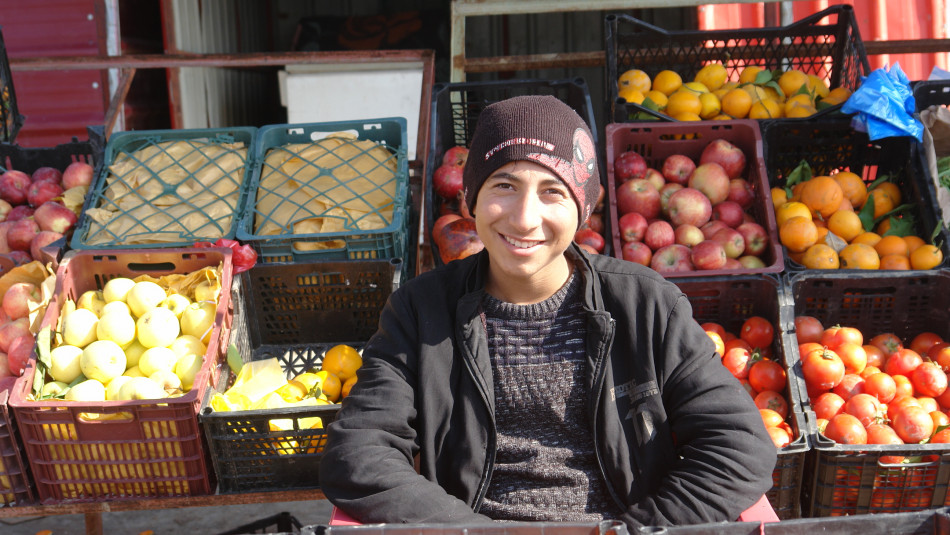 Renas, an IDP student, affords his family expenses from a grocery store