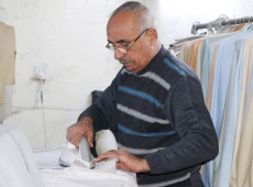 Mohammed spent his life in sewing Dishdasha (Thawb, Robe)